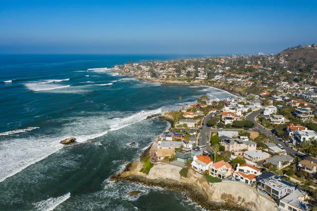 Aerial view of the cliffs, the surf and the ocean at Bird Rock.