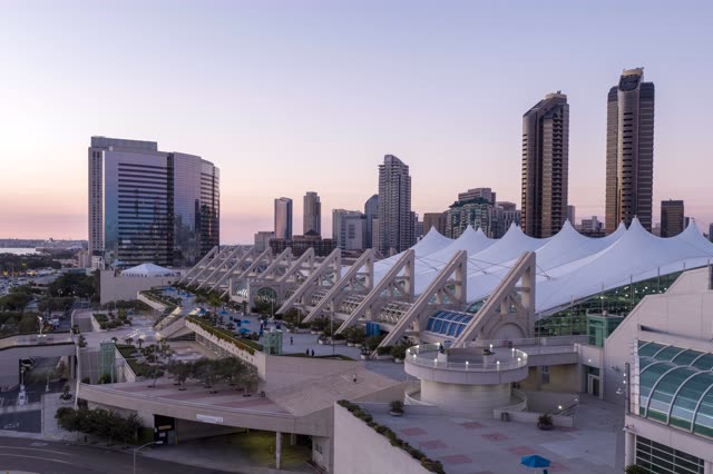 Low aerial view of the downtown streets, the skyline and palm trees at San Diego Marina.