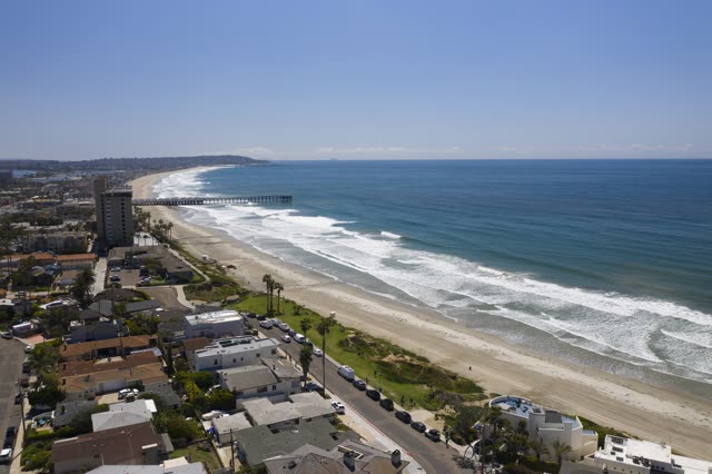 Aerial view of the beach, the surf and the pier in Pacific Beach.