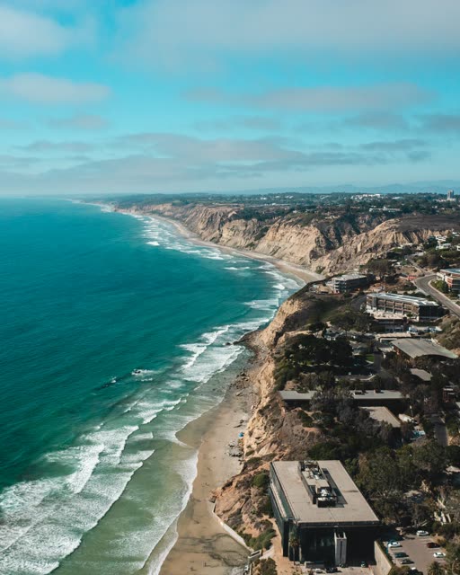 Aerial view of the cliffs, the surf and the ocean at La Jolla Farms.