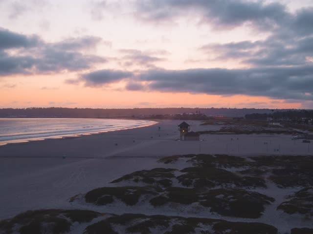 Low aerial view of the beach, the ocean and open country at Coronado Bridge.