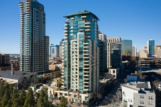 Low aerial view of the downtown streets, the skyline and the buildings at San Diego Marina.