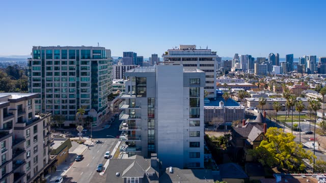 Low aerial view of the downtown streets, the skyline and palm trees at Bankers Hill.