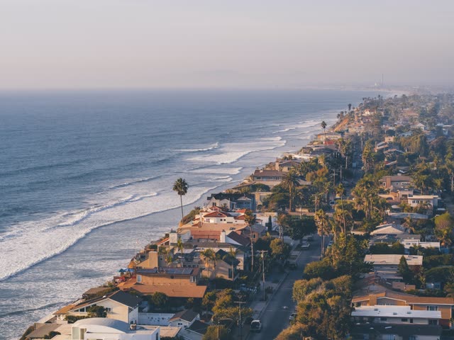 Aerial view of a residential street, the surf and palm trees in Encinitas.