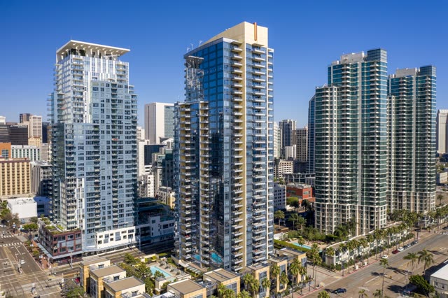 Low aerial view of the downtown streets, the skyline and palm trees at Waterfront.