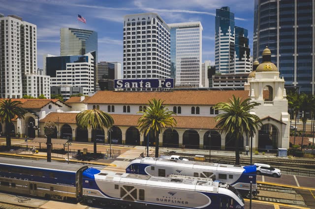 Low aerial view of the downtown streets, the skyline and palm trees at Waterfront.