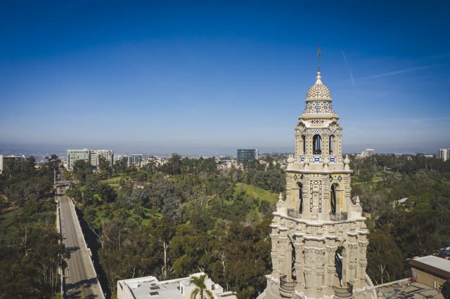Low aerial view of a park, the skyline and the buildings in Balboa Park.